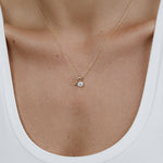 A decellotage wearing a Signature Cable Chain with a Princess Diamond Pendant and a Gold Letter Charm in A, and a white top. 