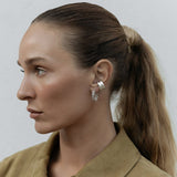 A Ready to Mingle Ear Cuff in sterling silver on a white background. 