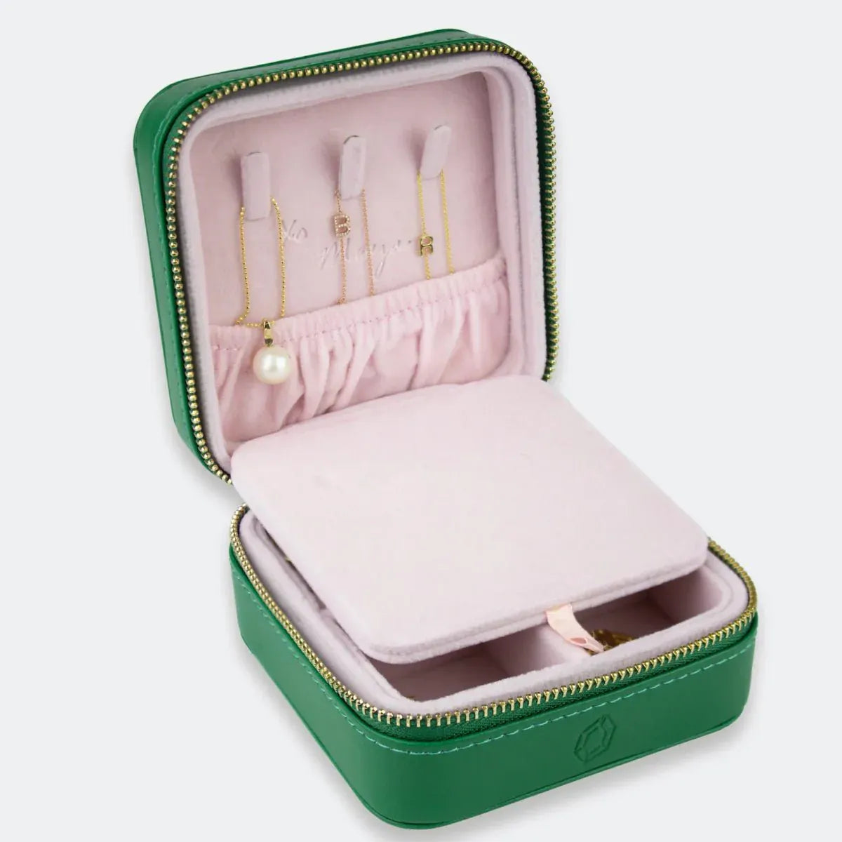 A Travel Jewelry Case - Green/Pink on a white background. 