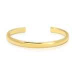 A gold vermeil Plus One Cuff on a white background. 