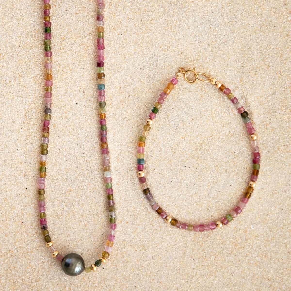 An Endless Summer Necklace - Sweet Escape and an Endless Summer Bracelet - Coral Reef on a sand background. 