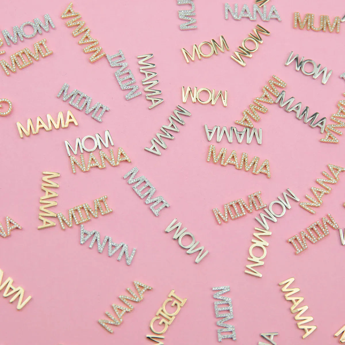 Yellow gold and white gold word plate pendants, some pavé, featuring MOM, MIMI, MAMA, NANA and GIGI, displayed on a pink background.