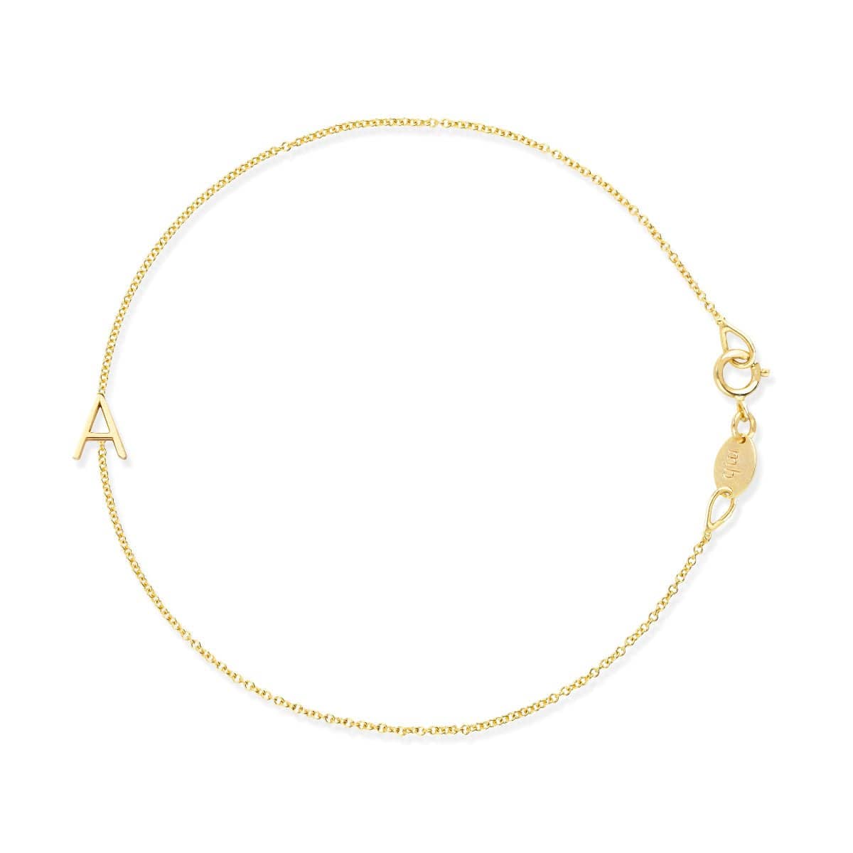 A gold cable chain bracelet with a letter A charm. 