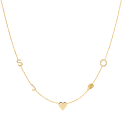 A Custom Gold Necklace in yellow gold with five charms, pave letters S, J and O, a heart and an angel wing, on a white background. 