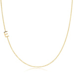 A gold necklace with a E letter charm on a white background. 