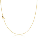 A gold necklace with a E letter charm on a white background. 
