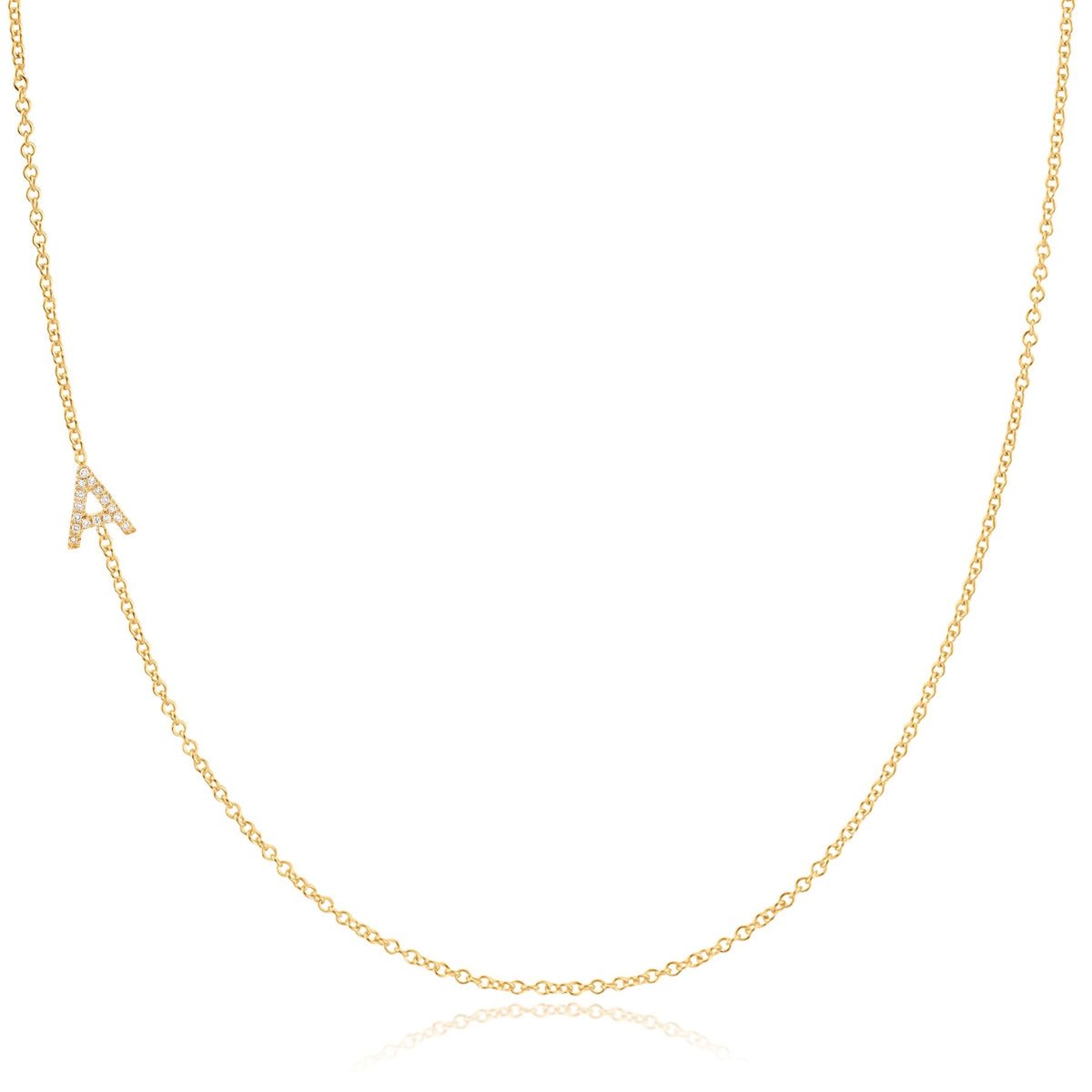 A gold necklace with a pave letter A charm on a white background.  