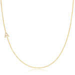 A gold necklace with a pave letter A charm on a white background.  
