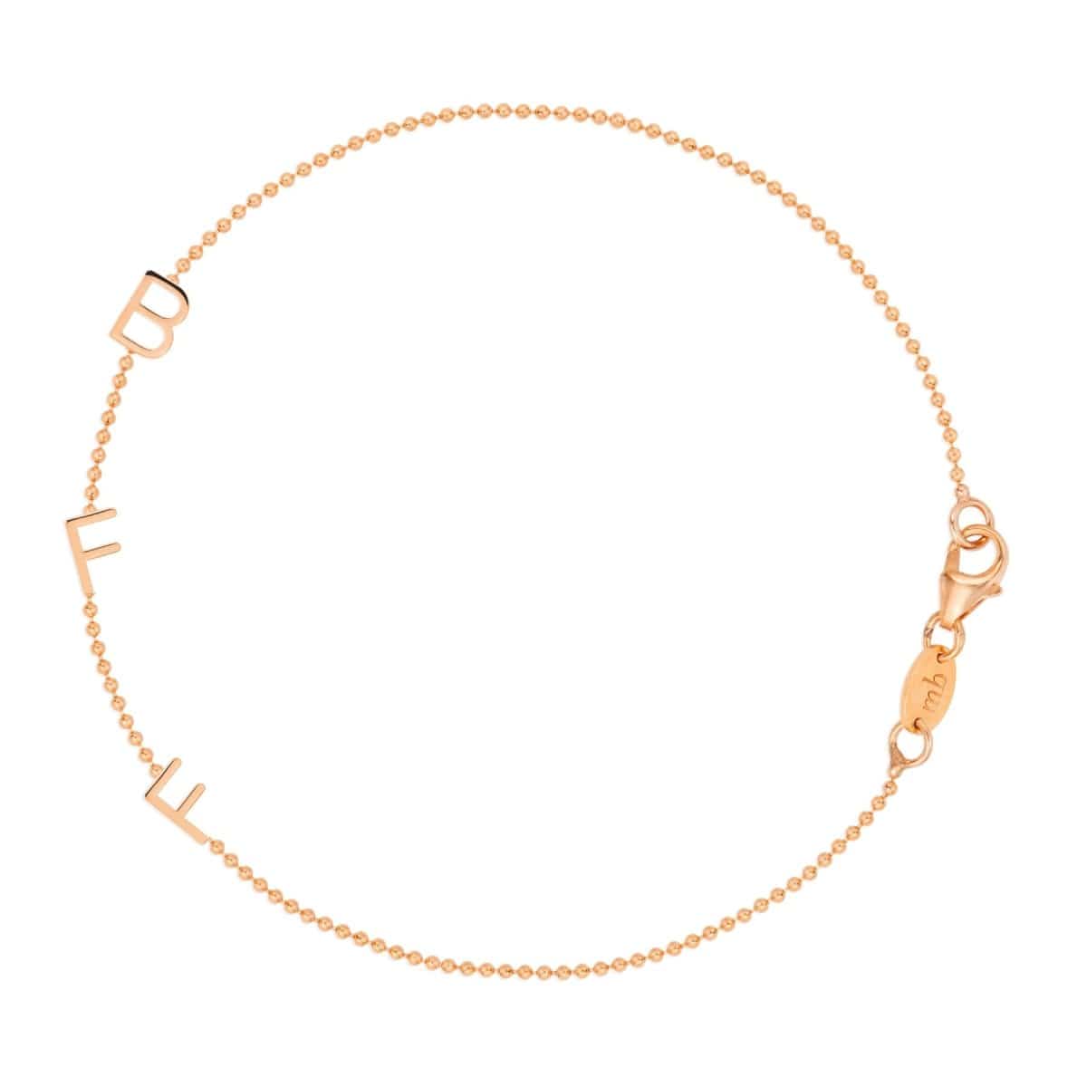 A rose gold BFF Bracelet in a beaded chain bracelet on a white background. 