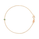 Rose gold bracelet with a small emerald green birthstone charm on a white background.