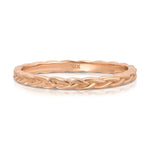 A Braided Ring in rose gold on a white background.