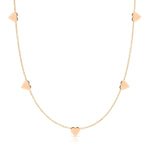 The 5 of Hearts Necklace in rose gold on a white background. 
