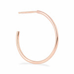 A Crescent Hoop / Large in rose gold on a white background.