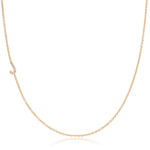 A rose gold necklace with a pave letter J charm on a white background. 