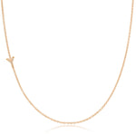 A rose gold necklace with a pave letter Y charm on a white background. 
