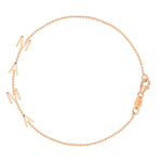 A Mama Bracelet in rose gold with a beaded chain on a white background. 