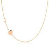 A Monogram Necklace with Heart Rose Gold and a letter J charm on a white background.
