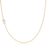A rose gold necklace with a B letter charm on a white background. 