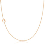 A rose gold necklace with a G letter charm on a white background. 