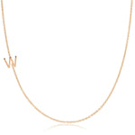 A rose gold necklace with a W letter charm on a white background. 