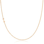 A rose gold necklace with an I letter charm on a white background. 