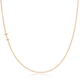 A rose gold necklace with an I letter charm on a white background. 