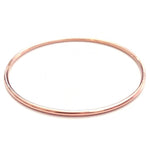 A rose gold Simple Bangle on a white background. 