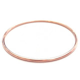 A rose gold Simple Bangle on a white background. 