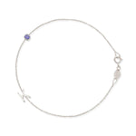 A white gold Custom Gold Bracelet - 2 Letters (a letter K charm and tanzanite birthstone) on a white background. 