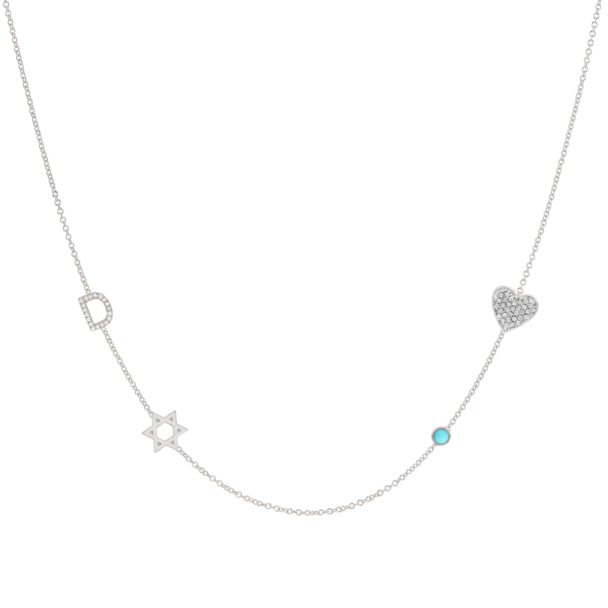 A Custom Gold Necklace in white gold with four charms, a pavé D and a Star of David positioned on the left side of the necklace, and a pavé heart and birthstone positioned on the right, on a white background.