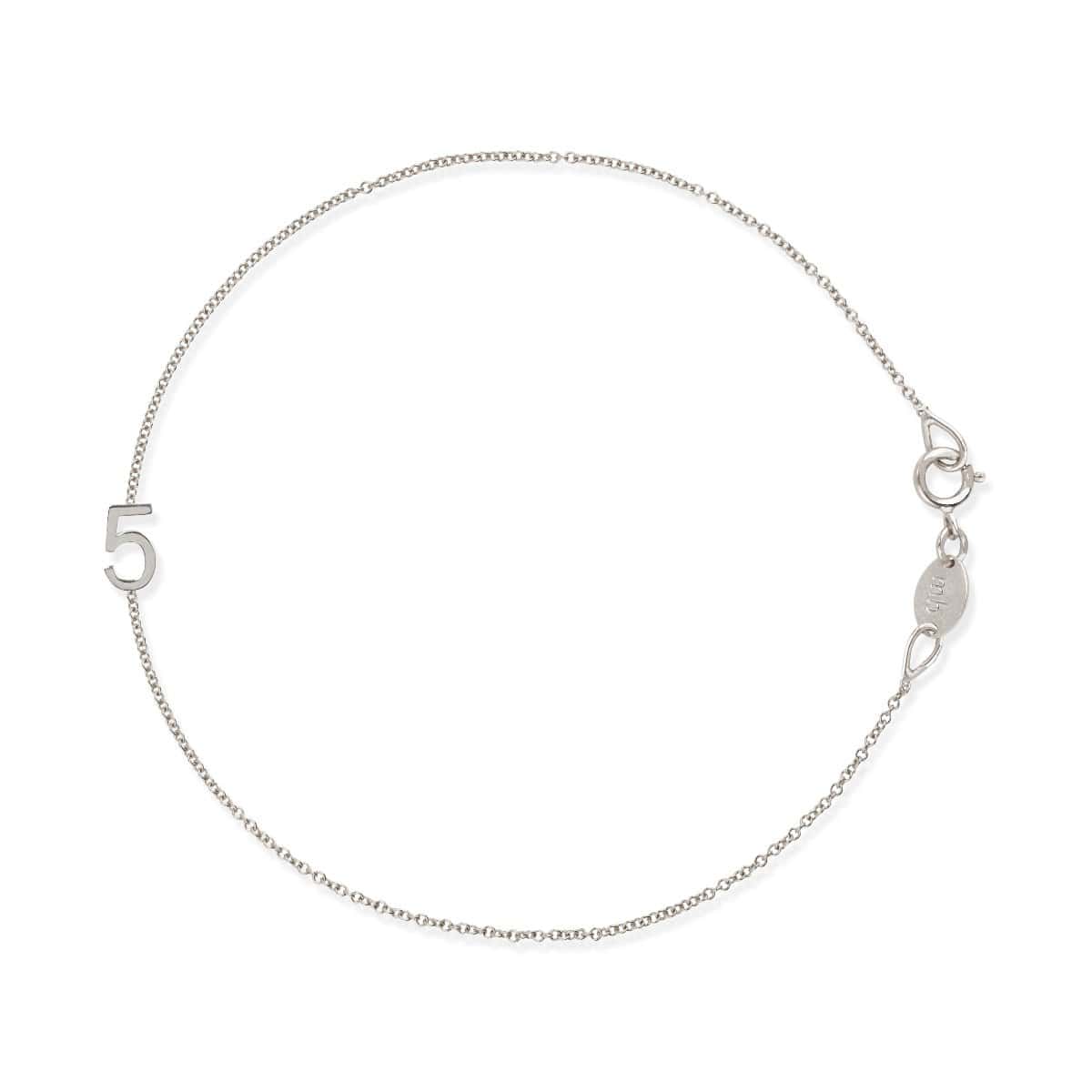 A white gold bracelet with a number 5 charm on a white background. 