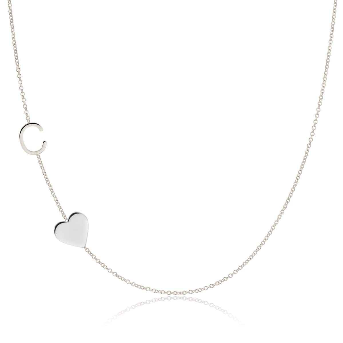 A Monogram Necklace with Heart White Gold and a letter C charm on a white background.