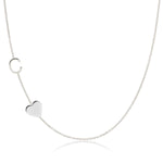A Monogram Necklace with Heart White Gold and a letter C charm on a white background.