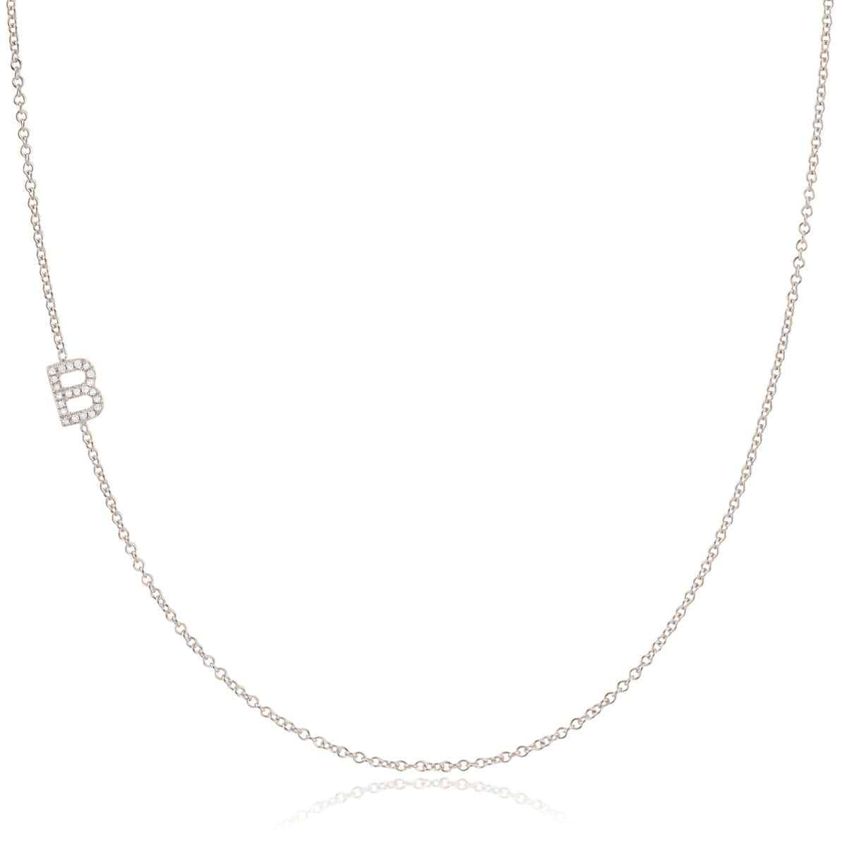 A white gold necklace with a B letter pave charm on a white background. 