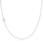 A white gold necklace with a B letter pave charm on a white background. 