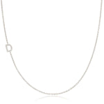 A white gold necklace with a D letter pave charm on a white background. 