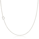 A white gold necklace with a D letter pave charm on a white background. 