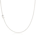 A white gold necklace with a E letter charm on a white background. 