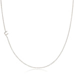 A white gold necklace with a F letter charm on a white background. 
