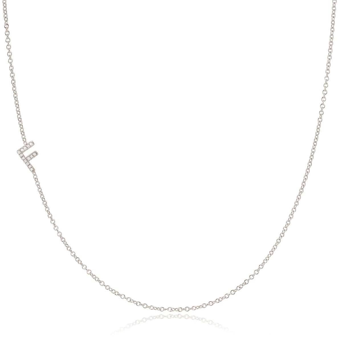 A white gold necklace with a F letter pave charm on a white background. 