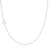 A white gold necklace with a G letter charm on a white background. 