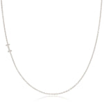 A white gold necklace with a letter I pave charm on a white background.