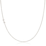 A white gold necklace with a letter I pave charm on a white background.