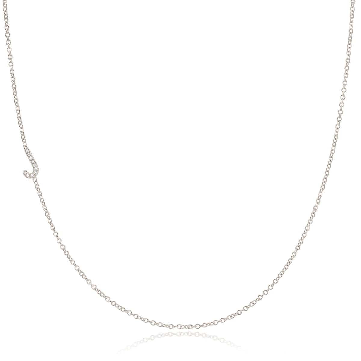 A white gold necklace with a letter J pave charm on a white background.