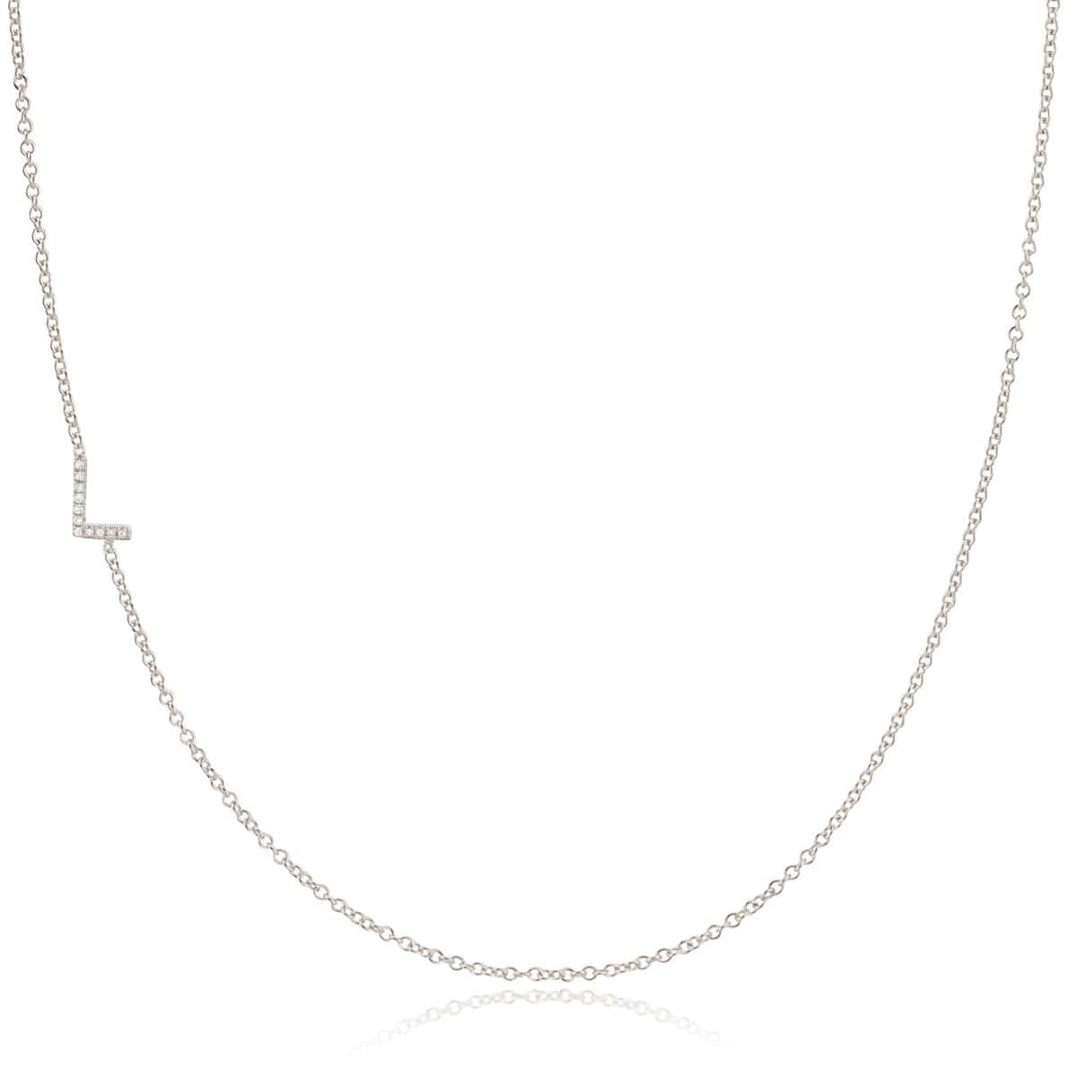 A white gold necklace with a letter L pave charm on a white background.