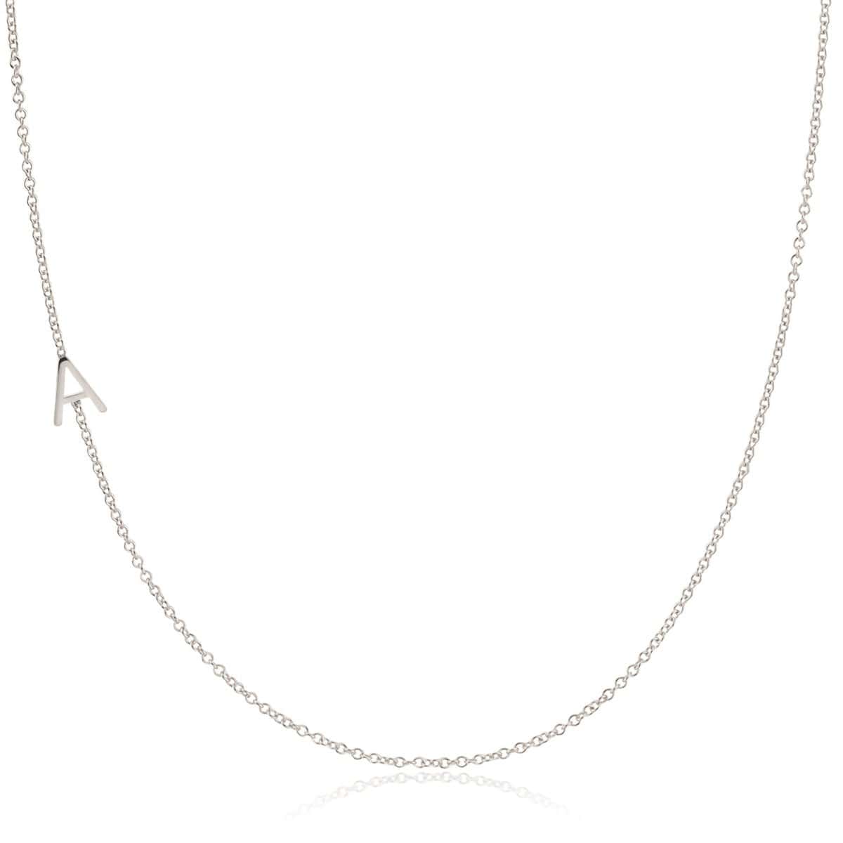 A white gold necklace with a letter A charm on a white background. 