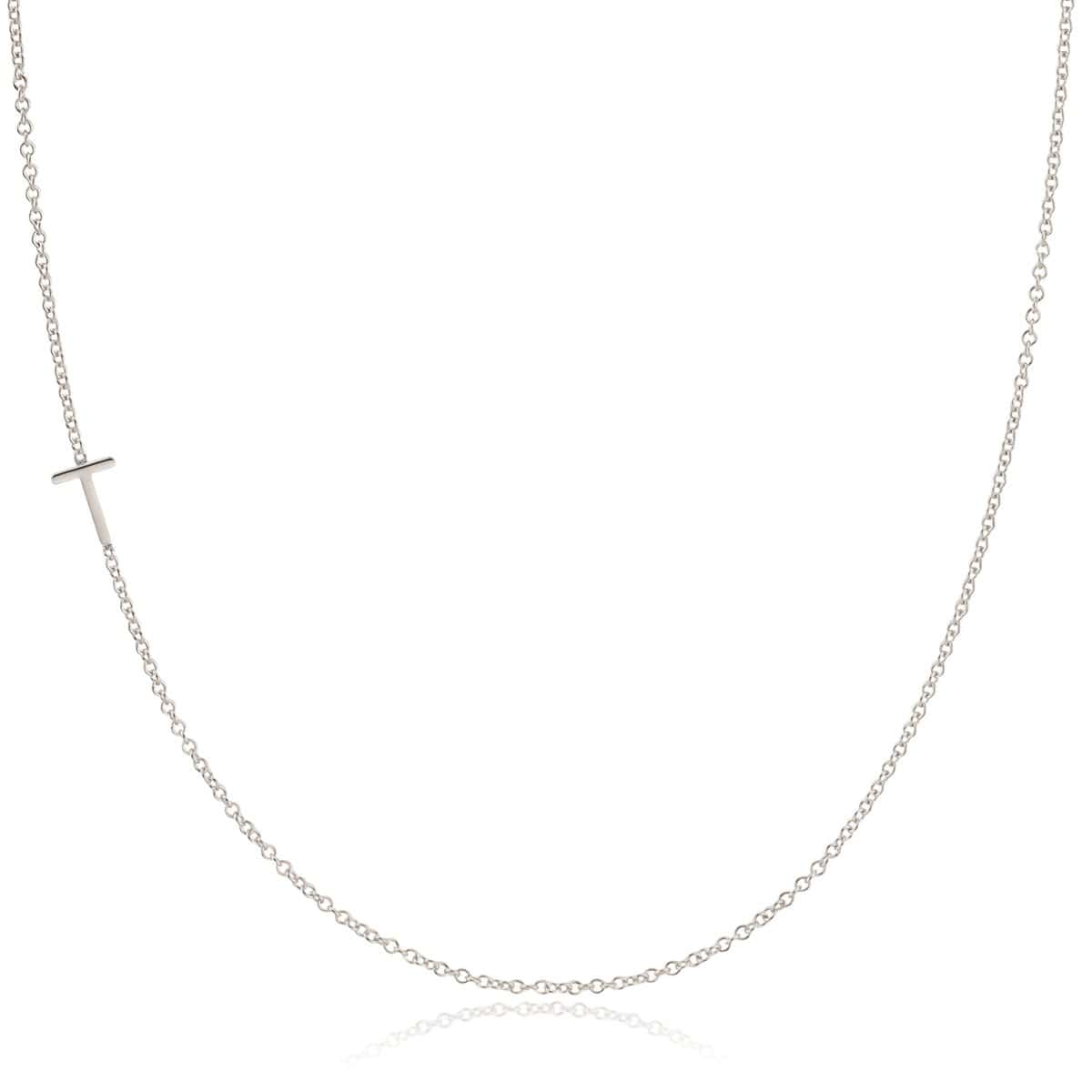 A white gold necklace with a T letter charm on a white background. 