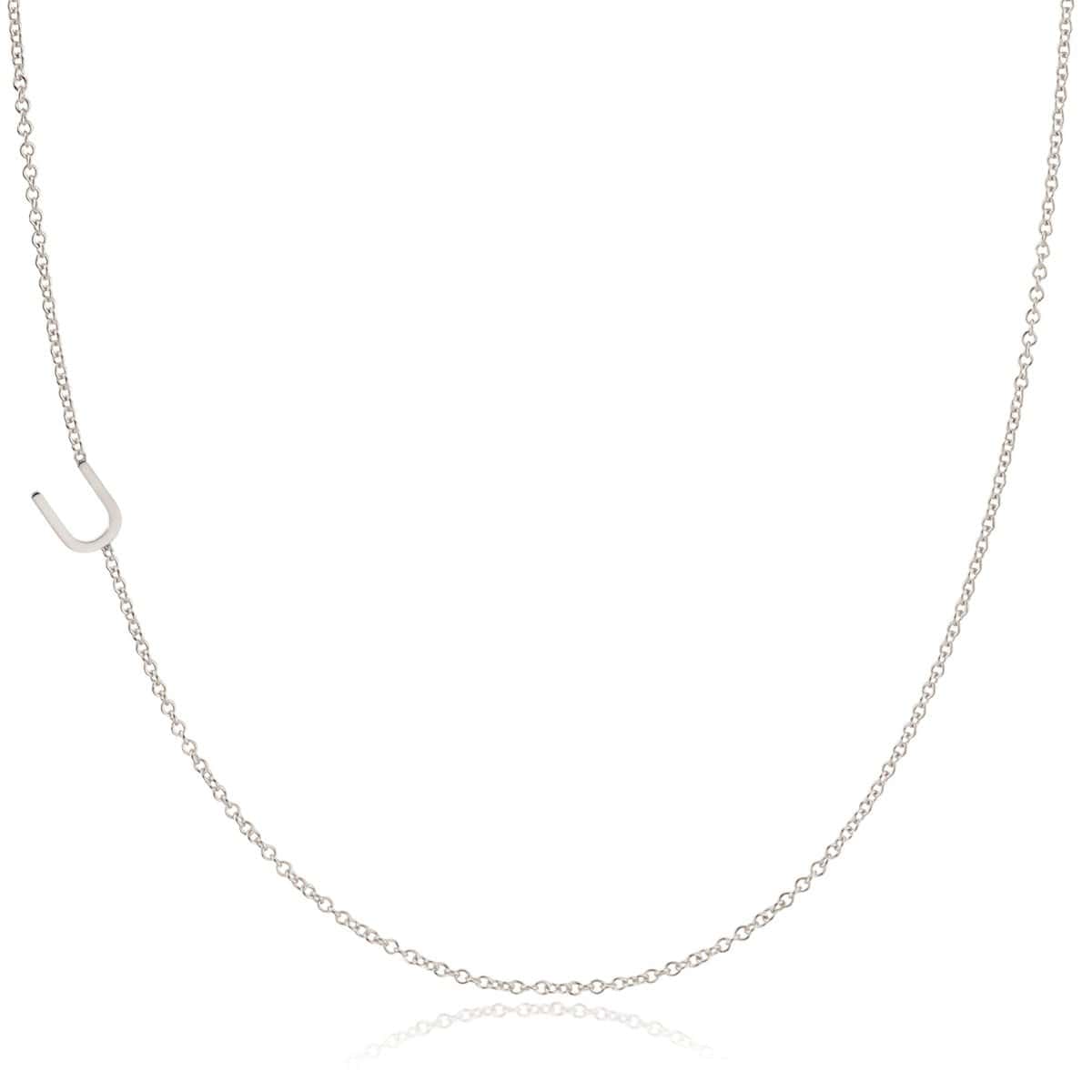 A white gold necklace with a U letter charm on a white background. 