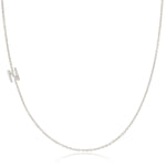 A white gold necklace with a letter N pave charm on a white background.