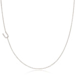 A white gold necklace with a letter U pave charm on a white background.